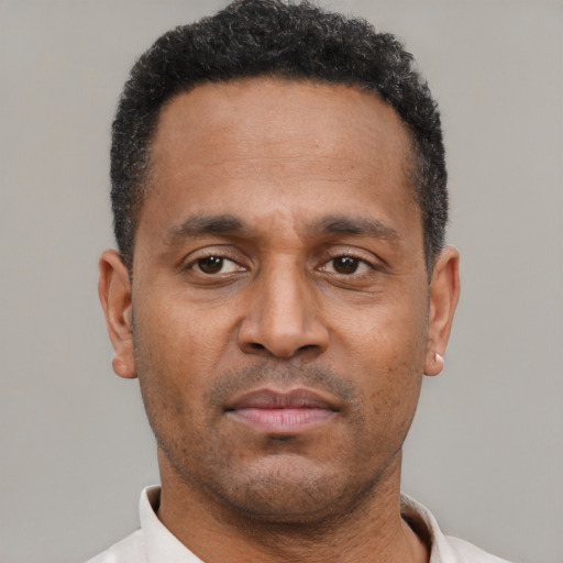 Neutral latino adult male with short  black hair and brown eyes