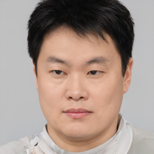 Neutral asian young-adult male with short  brown hair and brown eyes