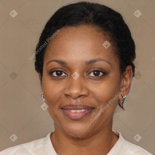 Joyful black adult female with short  brown hair and brown eyes