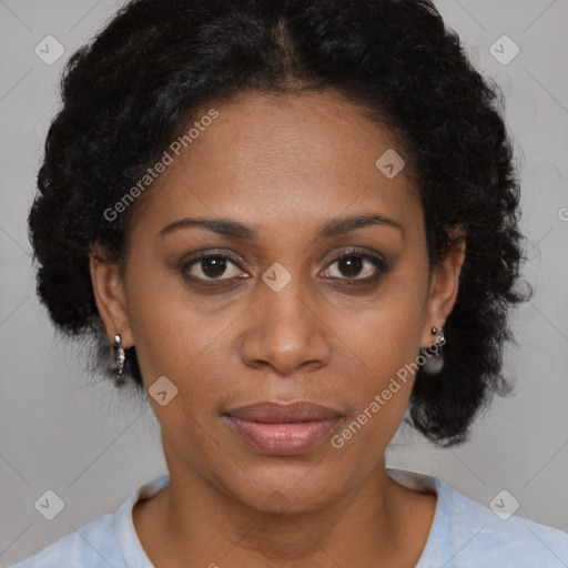 Joyful black adult female with short  brown hair and brown eyes