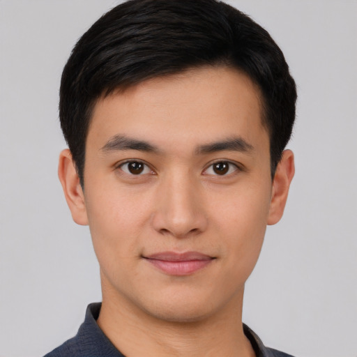 Joyful asian young-adult male with short  black hair and brown eyes