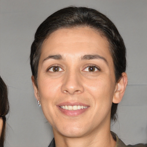 Joyful white young-adult female with medium  brown hair and brown eyes