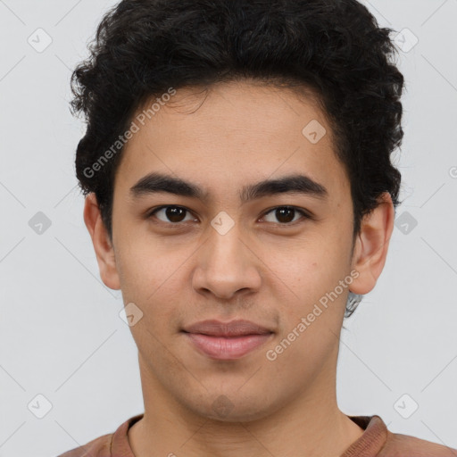 Joyful latino young-adult male with short  brown hair and brown eyes