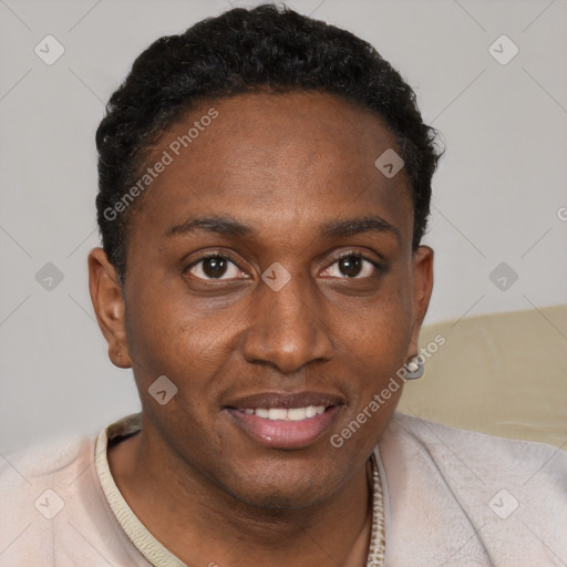 Joyful black young-adult male with short  brown hair and brown eyes