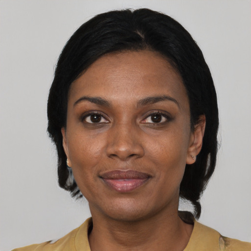 Joyful black adult female with short  black hair and brown eyes