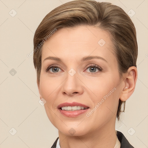 Joyful white adult female with medium  brown hair and grey eyes