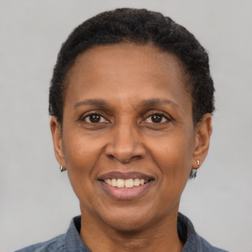 Joyful latino adult female with short  brown hair and brown eyes