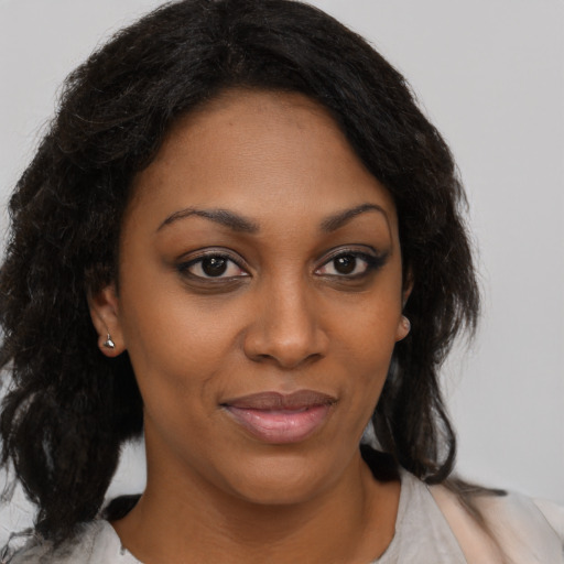 Joyful black young-adult female with medium  brown hair and brown eyes