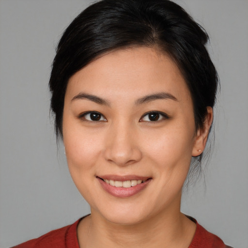 Joyful asian young-adult female with medium  brown hair and brown eyes