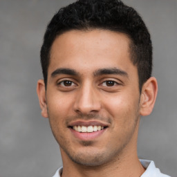 Joyful latino young-adult male with short  brown hair and brown eyes