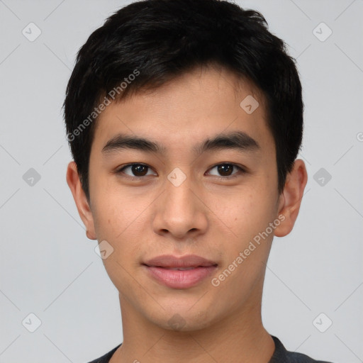 Joyful asian young-adult male with short  black hair and brown eyes