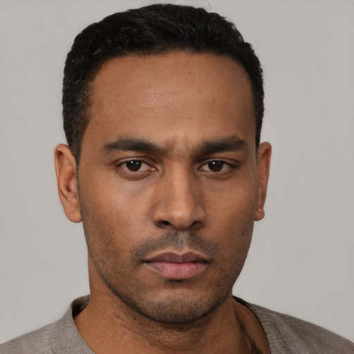 Neutral latino young-adult male with short  black hair and brown eyes