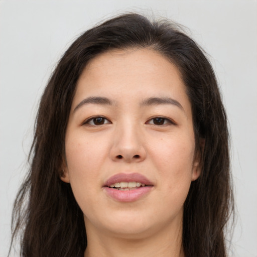 Joyful asian young-adult female with long  brown hair and brown eyes