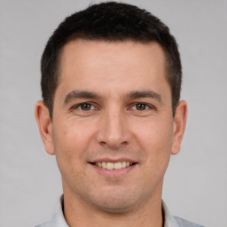 Joyful white young-adult male with short  brown hair and brown eyes