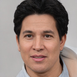 Joyful white adult male with short  black hair and brown eyes