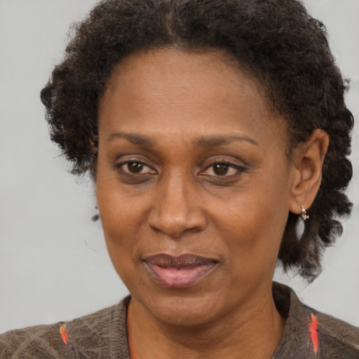 Joyful black adult female with short  brown hair and brown eyes