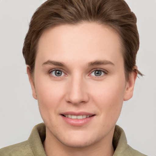 Joyful white young-adult female with short  brown hair and grey eyes