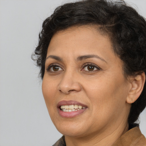 Joyful white adult female with short  brown hair and brown eyes