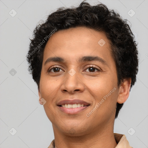 Joyful latino young-adult male with short  brown hair and brown eyes