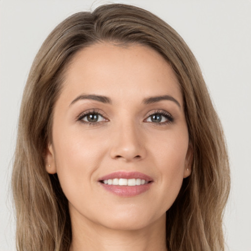 Joyful white young-adult female with long  brown hair and brown eyes