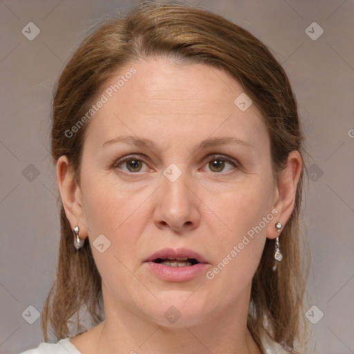 Joyful white adult female with medium  brown hair and grey eyes