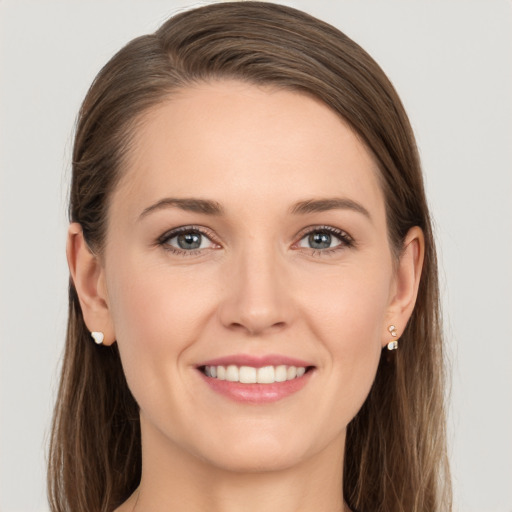 Joyful white young-adult female with long  brown hair and grey eyes