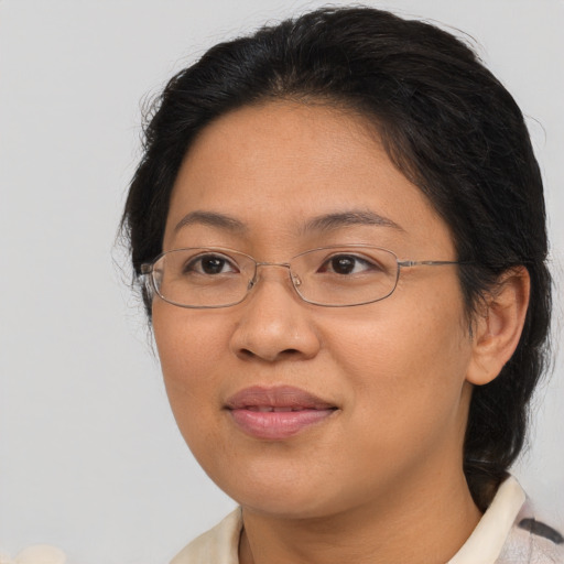 Joyful asian adult female with medium  brown hair and brown eyes