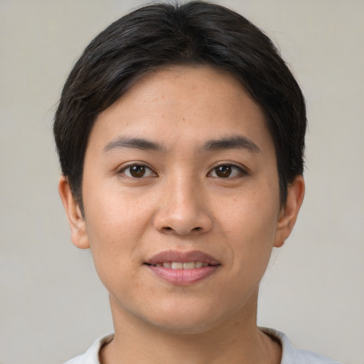 Joyful asian young-adult female with short  brown hair and brown eyes