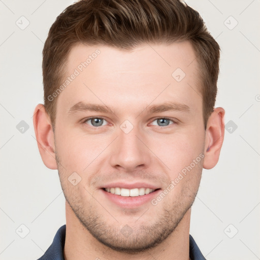 Joyful white young-adult male with short  brown hair and grey eyes