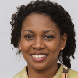 Joyful black adult female with short  brown hair and brown eyes