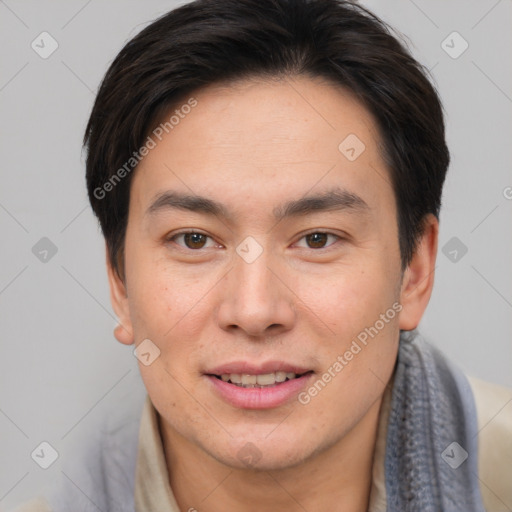 Joyful asian young-adult male with short  brown hair and brown eyes