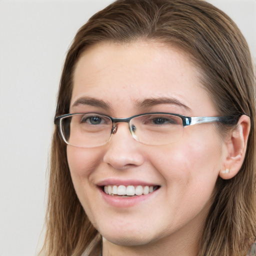 Joyful white young-adult female with long  brown hair and blue eyes