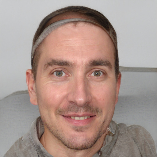 Joyful white adult male with short  brown hair and grey eyes