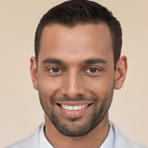 Joyful white young-adult male with short  brown hair and brown eyes