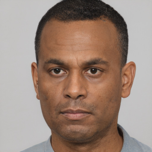 Neutral latino adult male with short  black hair and brown eyes