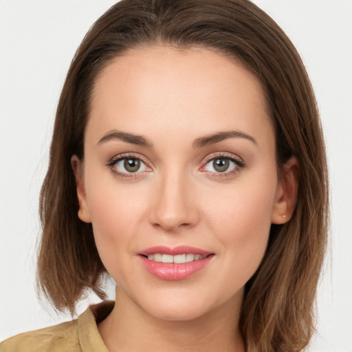 Joyful white young-adult female with long  brown hair and grey eyes