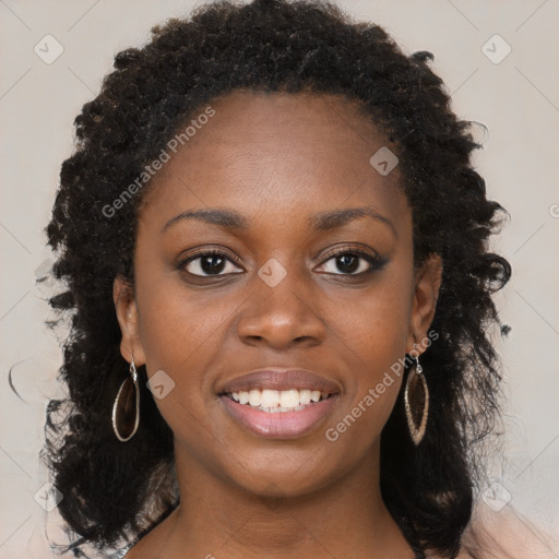 Joyful black young-adult female with long  brown hair and brown eyes