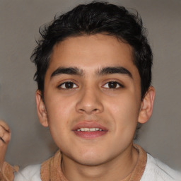 Joyful latino young-adult male with short  brown hair and brown eyes