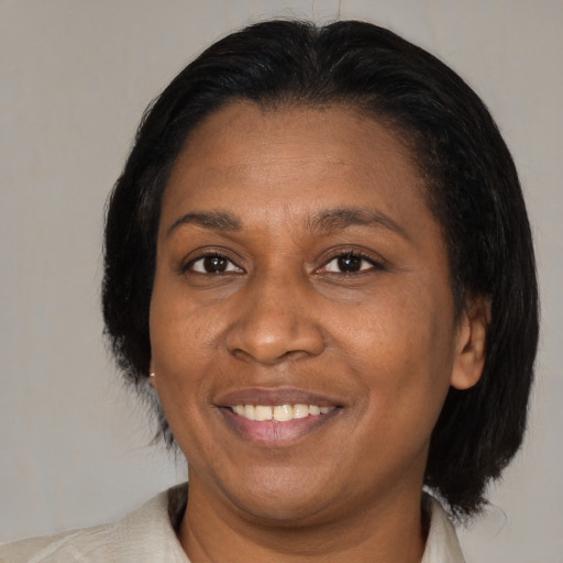 Joyful black adult female with medium  black hair and brown eyes
