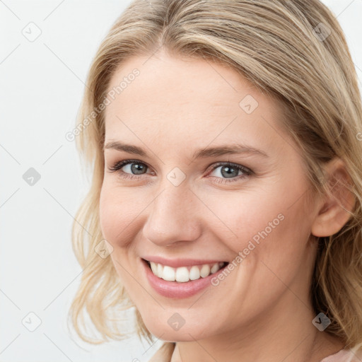 Joyful white young-adult female with medium  brown hair and blue eyes