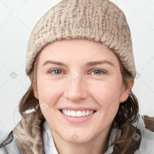 Joyful white young-adult female with medium  brown hair and blue eyes