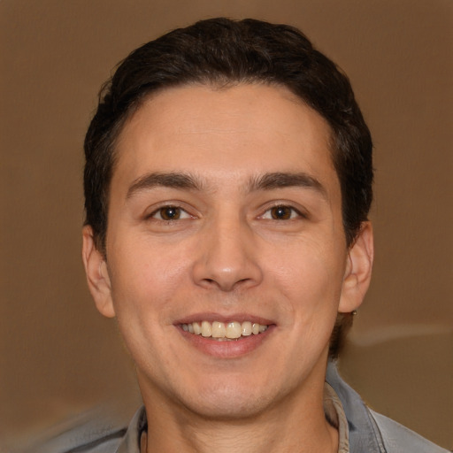 Joyful white adult male with short  brown hair and brown eyes