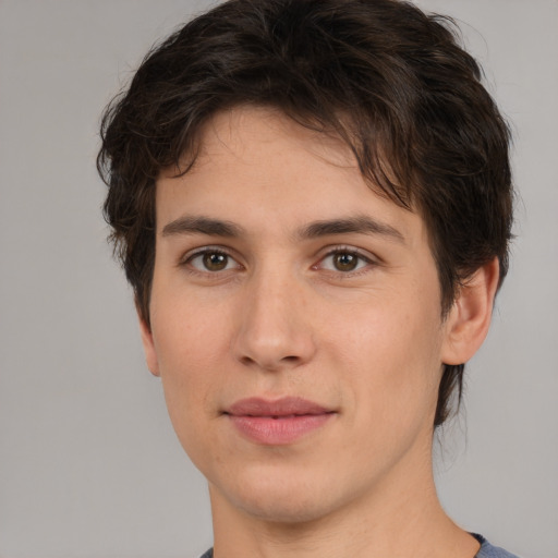 Joyful white young-adult male with medium  brown hair and brown eyes