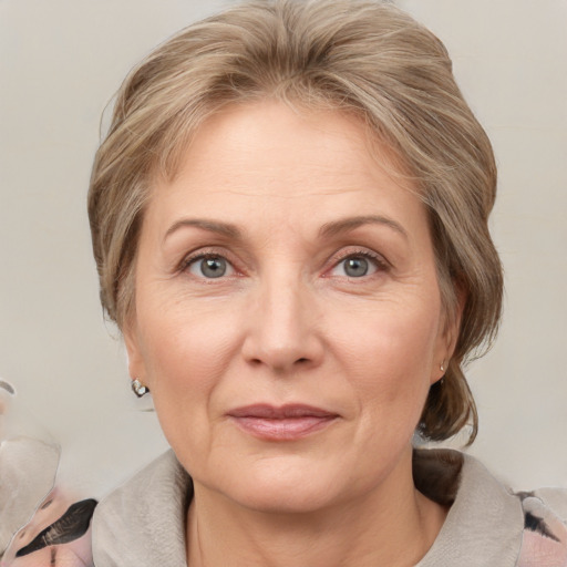 Joyful white adult female with medium  brown hair and grey eyes