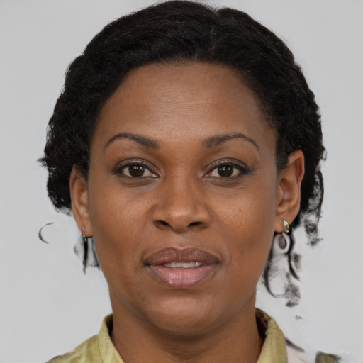Joyful black adult female with medium  brown hair and brown eyes