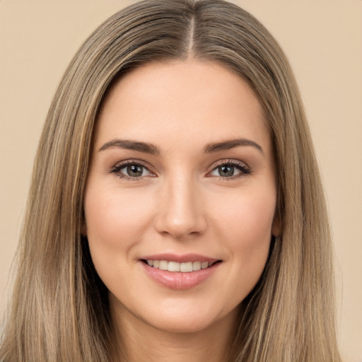 Joyful white young-adult female with long  brown hair and brown eyes