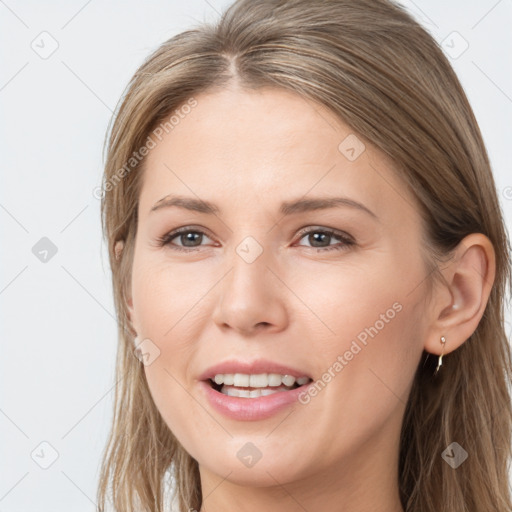 Joyful white young-adult female with long  brown hair and brown eyes