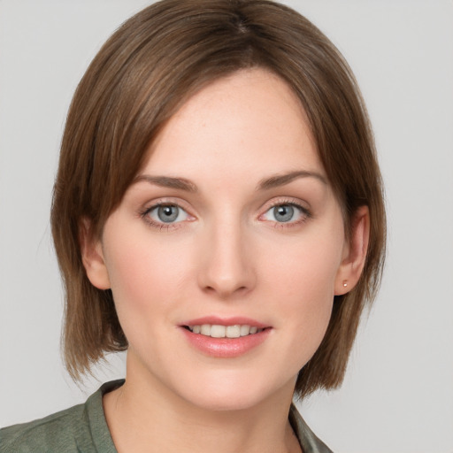 Joyful white young-adult female with medium  brown hair and grey eyes