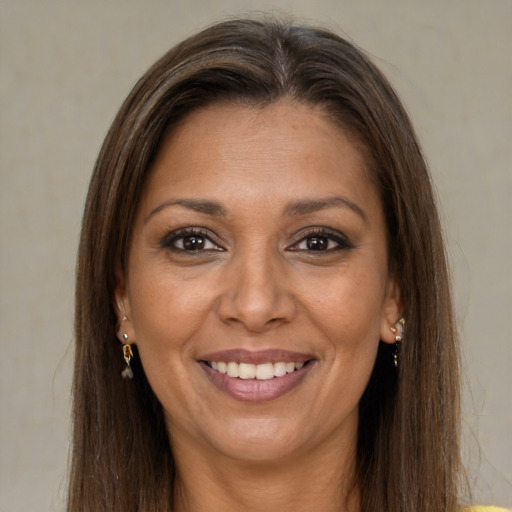 Joyful white adult female with long  brown hair and brown eyes
