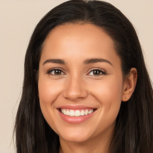 Joyful white young-adult female with long  brown hair and brown eyes